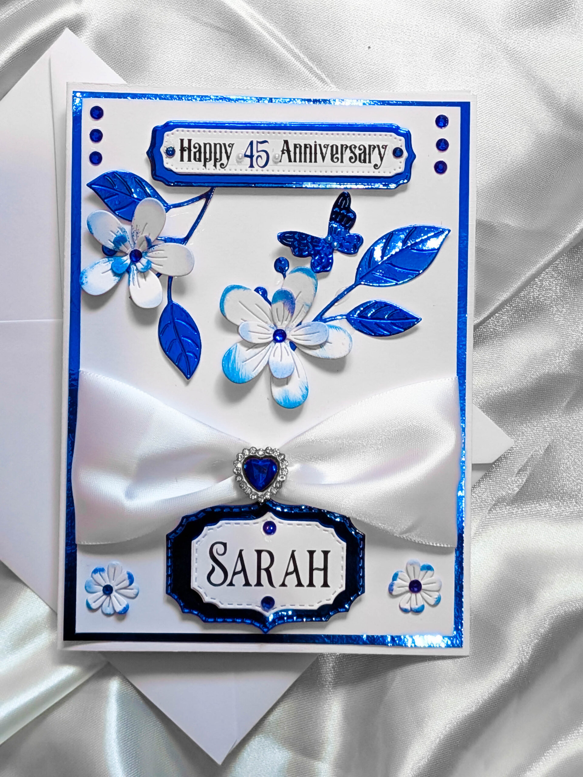 Front-on photograph of a handmade card with the custom top message: 'Happy 45th Anniversary