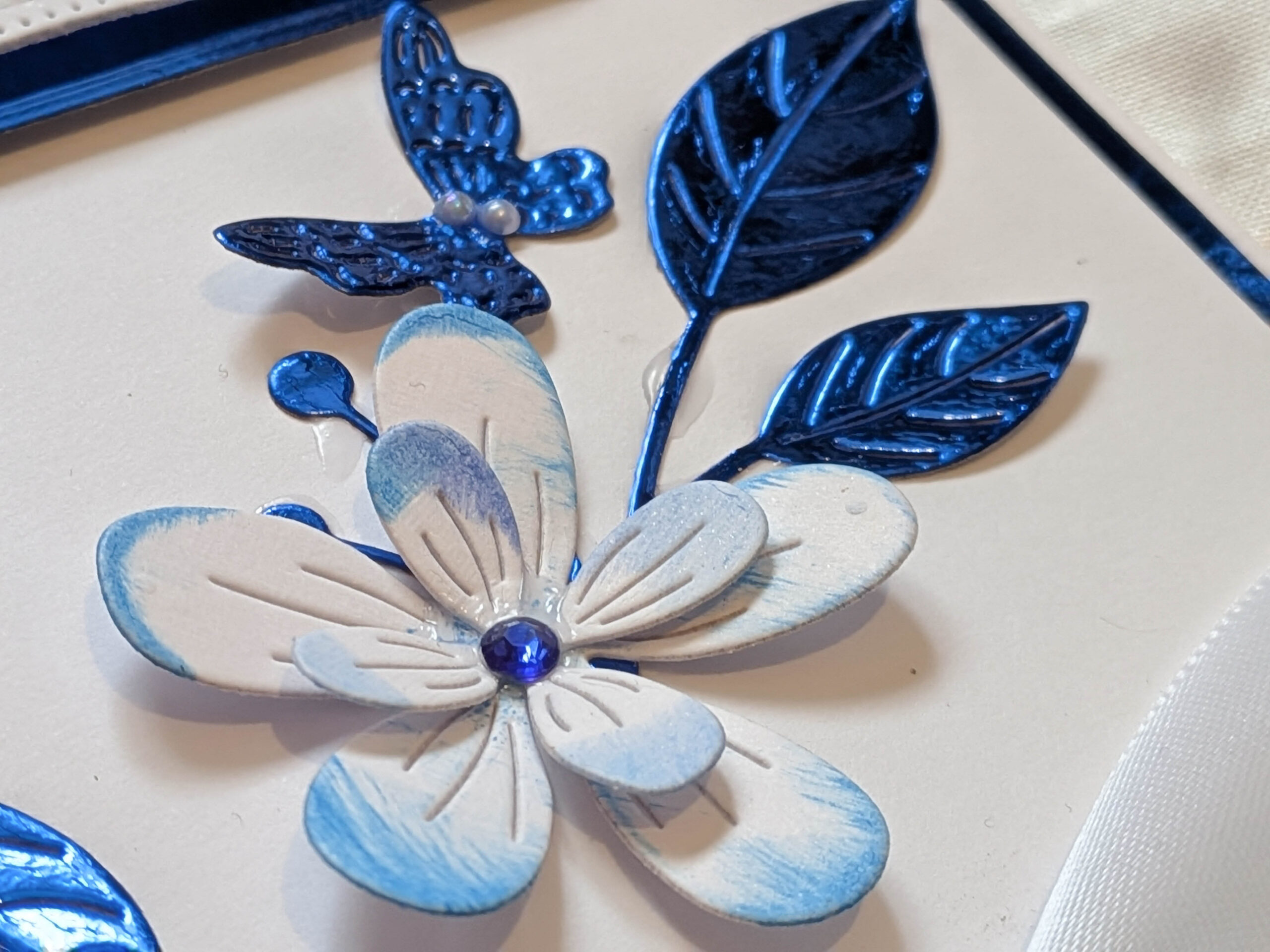 A view of the 3D floral arrangement and blue butterfly on a custom greeting card.