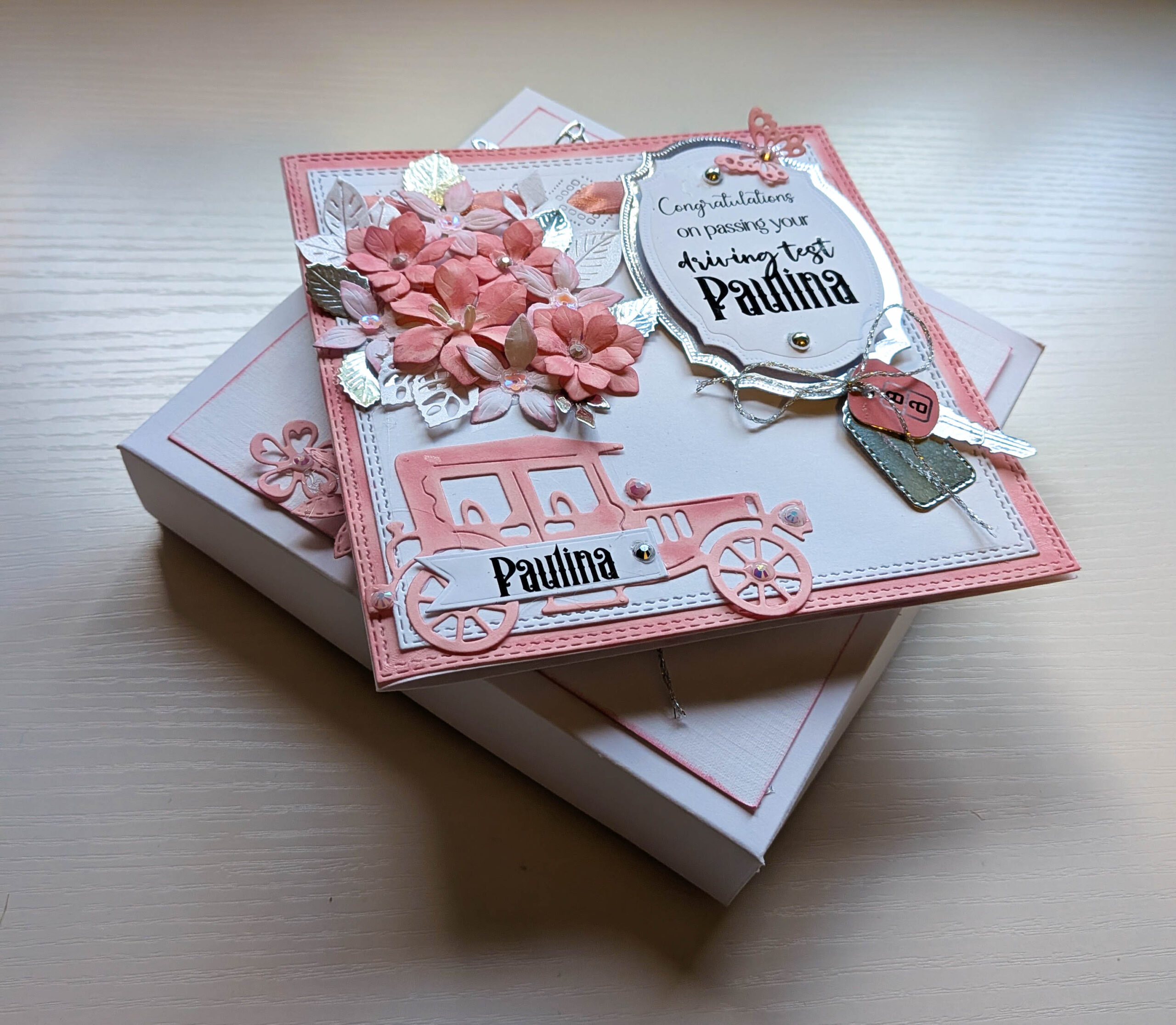 Handmade personalised pink luxury boxed driving test congratulations card shown with decorated matching presentation gift box.