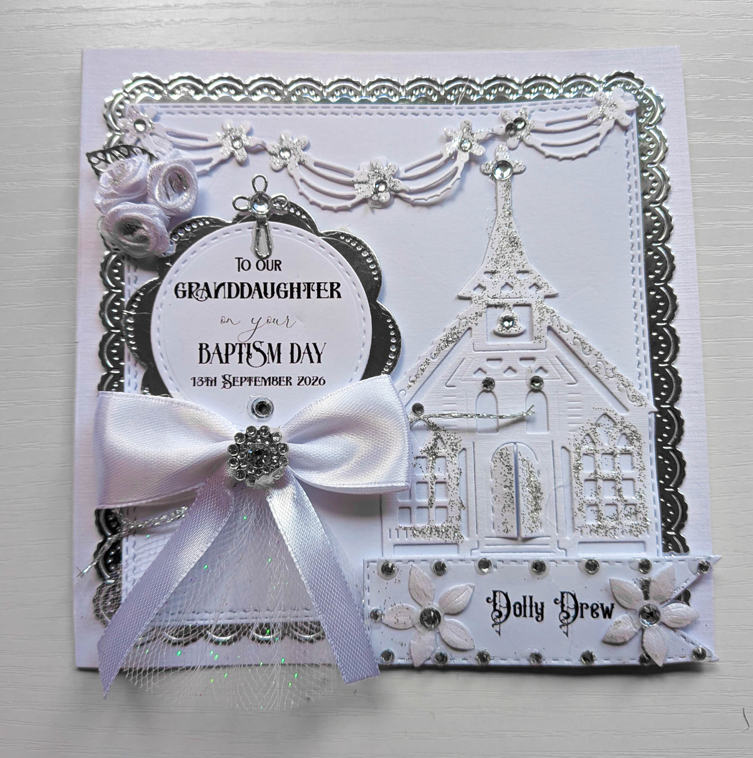Front view of 15cm baptism keepsake card personalised for a granddaughter with church cut-out and silver cross.